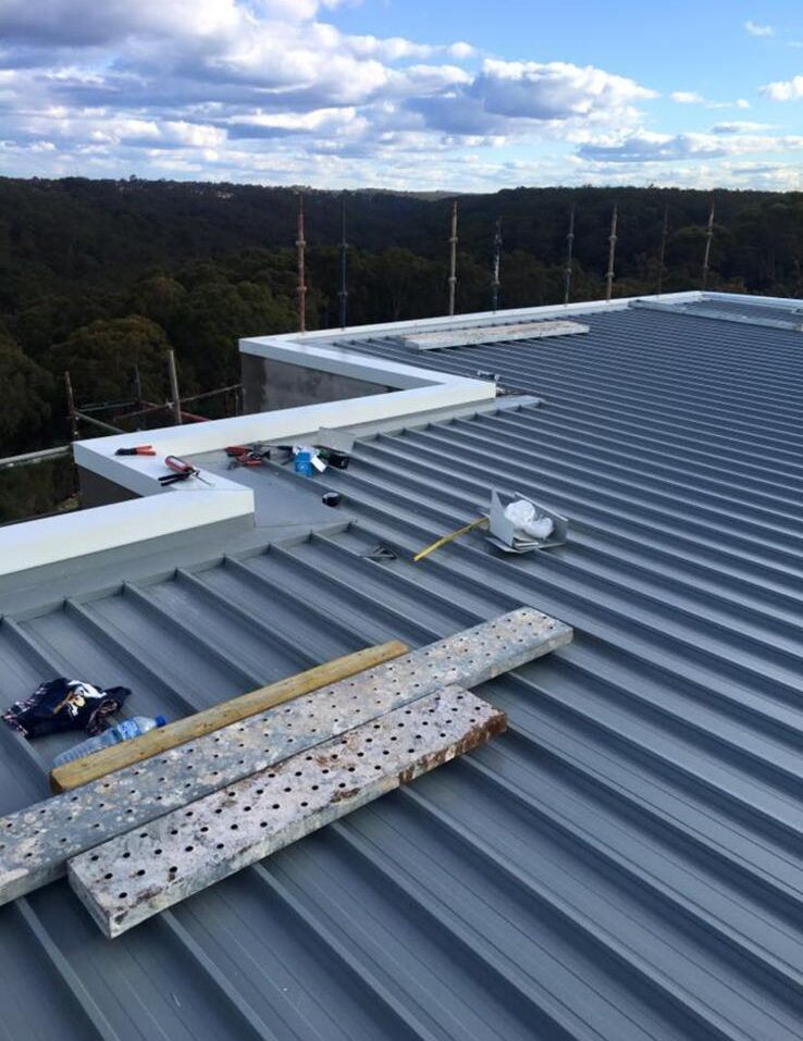 Roofer inspecting storm damage on a Brisbane tile roof